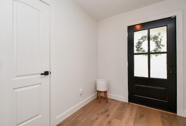 entryway with light wood-style flooring and baseboards