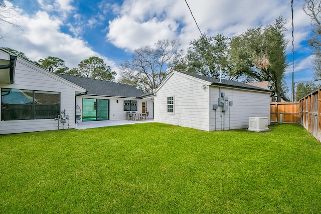 back of house featuring a yard, a patio, and a fenced backyard