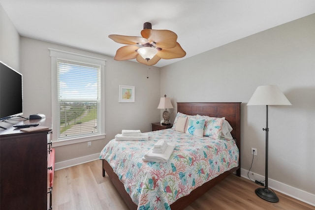 26501 Mangrove Dr Unit 203, Galveston, TX 77554 - bedroom with light wood-style flooring and ceiling fan