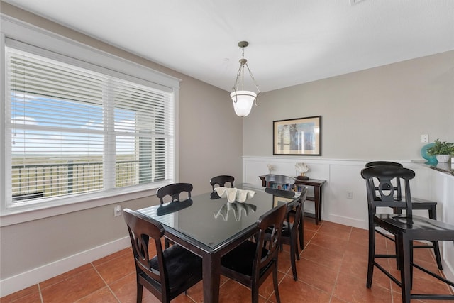 26501 Mangrove Dr Unit 203, Galveston, TX 77554 - dining area with tile patterned flooring and wainscoting