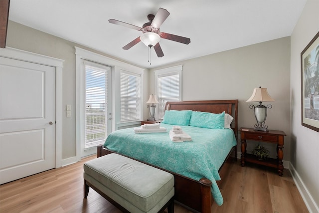 26501 Mangrove Dr Unit 203, Galveston, TX 77554 - bedroom with access to exterior, light wood-style floors, and multiple windows