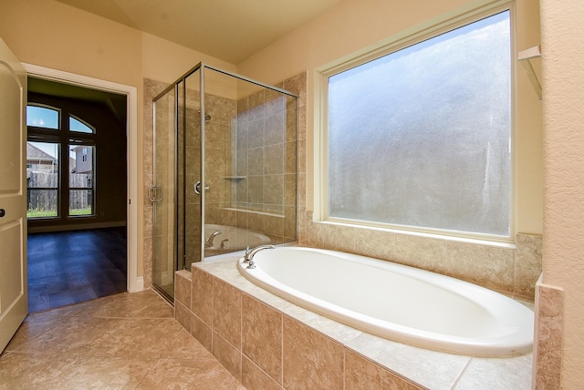 bathroom featuring a garden tub and a stall shower