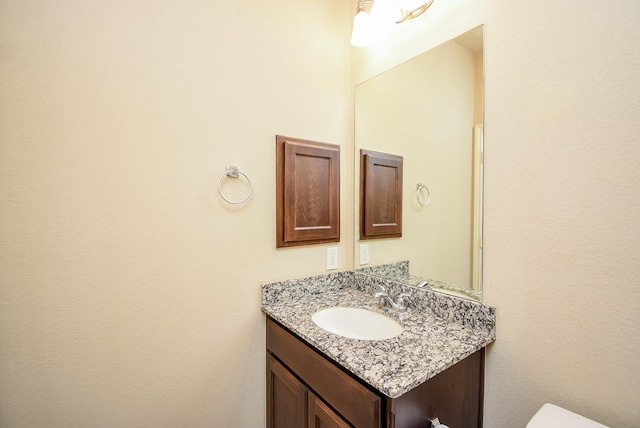 bathroom featuring toilet and vanity