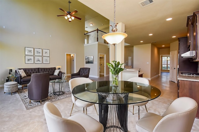 dining area with visible vents, recessed lighting, a high ceiling, baseboards, and ceiling fan