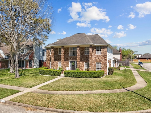 view of front of home featuring a front lawn and brick siding