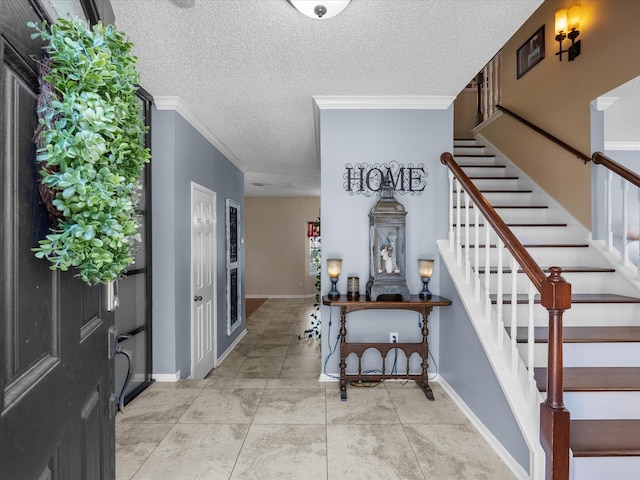 entrance foyer with stairway, a textured ceiling, baseboards, and ornamental molding