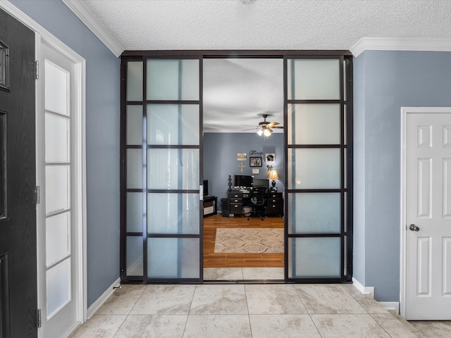 interior space featuring crown molding, light tile patterned floors, and a textured ceiling