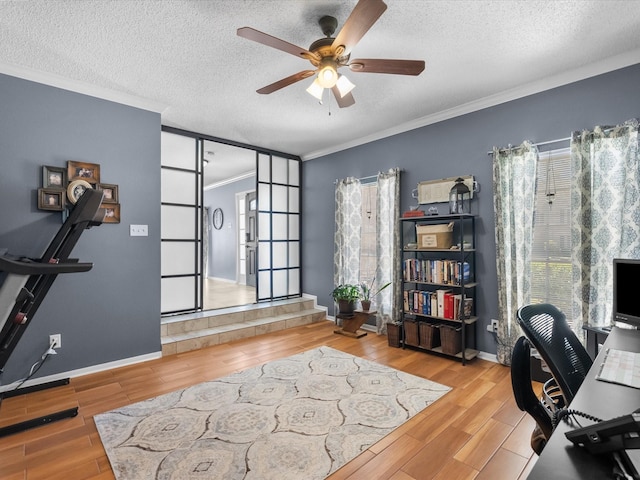 office space with a textured ceiling, crown molding, wood finished floors, and ceiling fan