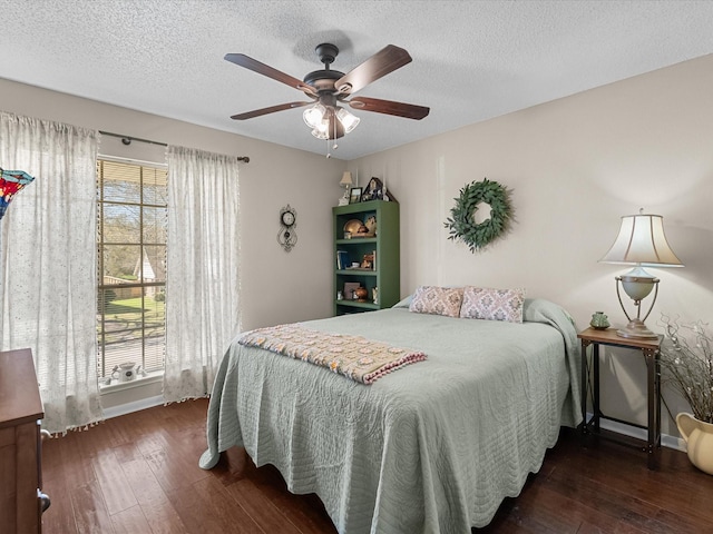 bedroom with hardwood / wood-style flooring, multiple windows, and a textured ceiling