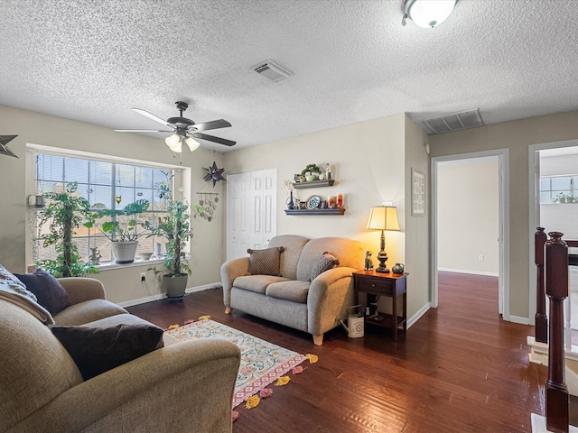 living room with visible vents, baseboards, ceiling fan, and wood finished floors