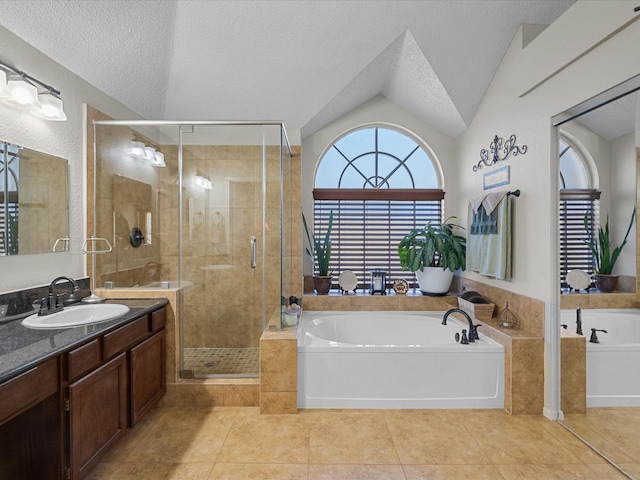 full bath featuring a bath, a stall shower, vanity, and a textured ceiling