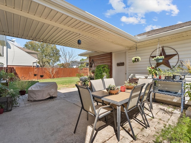 view of patio featuring outdoor dining space and fence