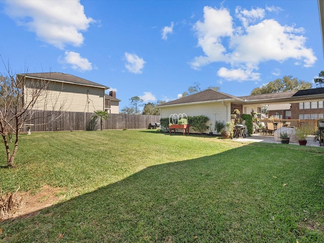 view of yard with a patio area and a fenced backyard