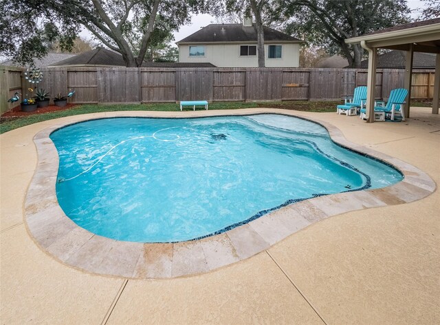 view of swimming pool with a patio area and a fenced backyard