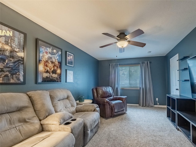 living room featuring carpet flooring, baseboards, and ceiling fan