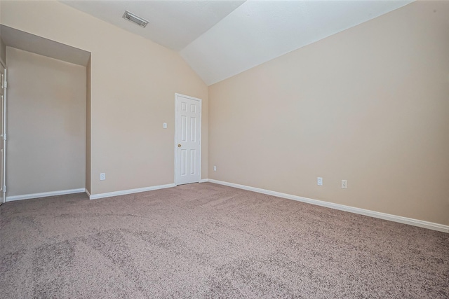 carpeted empty room with visible vents, baseboards, and vaulted ceiling