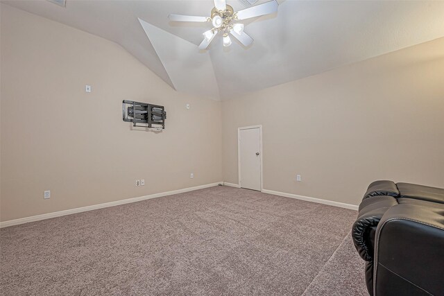 living area featuring vaulted ceiling, carpet flooring, a ceiling fan, and baseboards