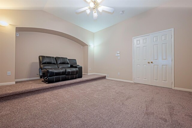 sitting room with carpet flooring, ceiling fan, baseboards, and lofted ceiling