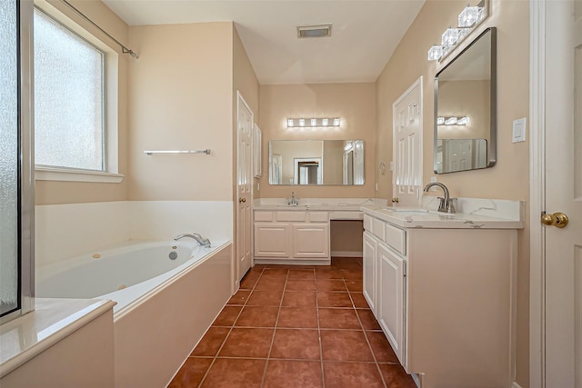 full bathroom featuring tile patterned floors, a garden tub, visible vents, and a sink