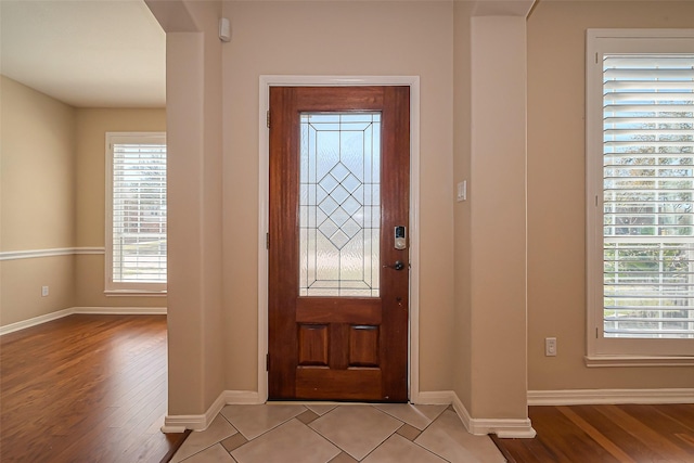 entrance foyer with light wood-type flooring and baseboards