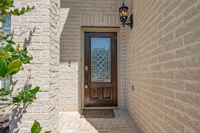 property entrance with brick siding and stone siding