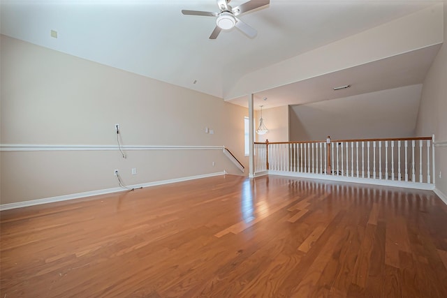 unfurnished room featuring light wood-type flooring, baseboards, ceiling fan, and vaulted ceiling