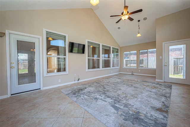 unfurnished sunroom featuring vaulted ceiling and a ceiling fan