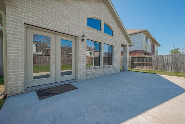 exterior space with french doors and fence