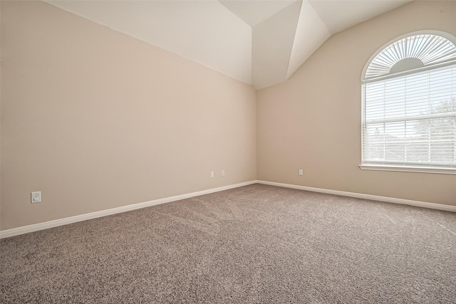 unfurnished room featuring baseboards, carpet floors, and vaulted ceiling