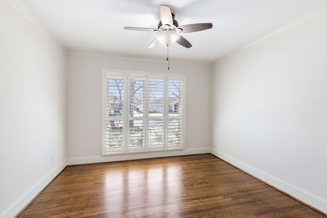 spare room with ceiling fan, baseboards, wood finished floors, and crown molding