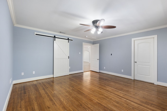 unfurnished bedroom featuring crown molding, wood finished floors, and baseboards