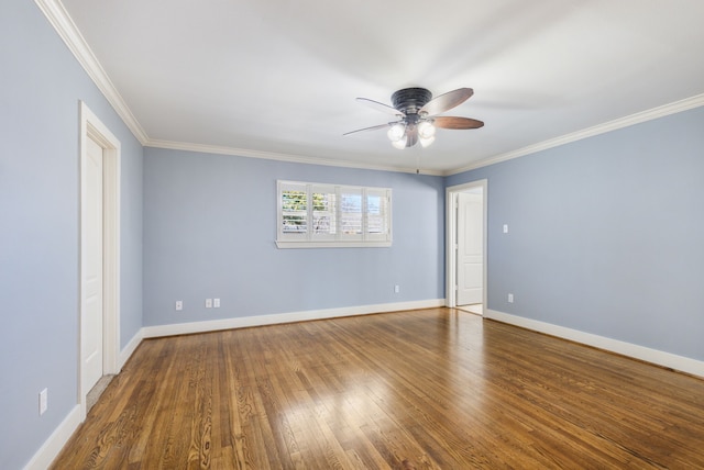 empty room featuring ceiling fan, baseboards, wood finished floors, and ornamental molding