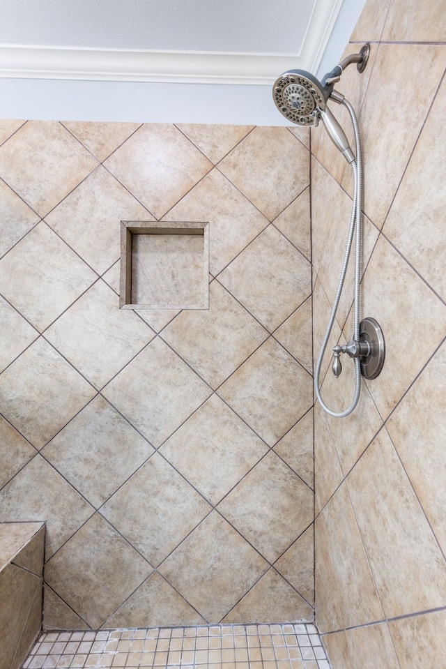 room details featuring tiled shower and ornamental molding