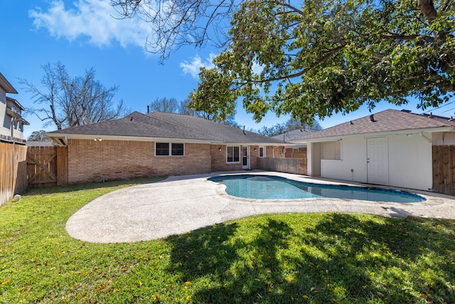 view of swimming pool featuring a yard, a patio, a fenced in pool, and a fenced backyard