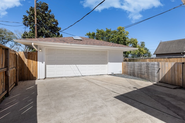 detached garage featuring fence