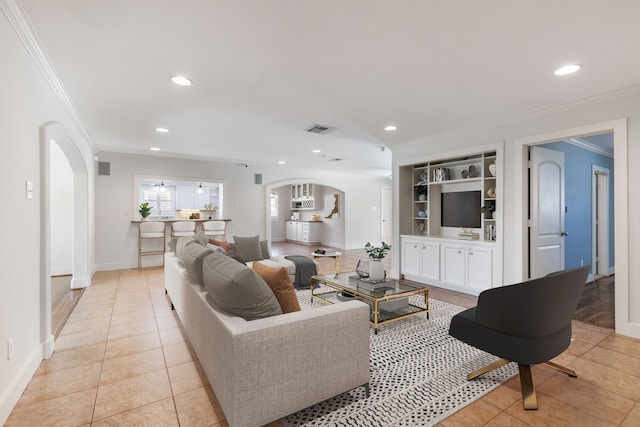 living area featuring visible vents, ornamental molding, light tile patterned floors, recessed lighting, and arched walkways