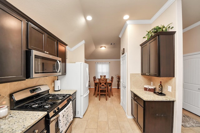 kitchen with dark brown cabinets, light stone counters, appliances with stainless steel finishes, and ornamental molding