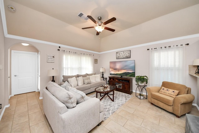 living area featuring arched walkways, visible vents, plenty of natural light, and ceiling fan