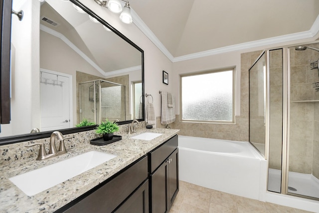 bathroom featuring a sink, ornamental molding, a shower stall, and vaulted ceiling