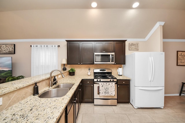 kitchen featuring light stone counters, a sink, dark brown cabinets, appliances with stainless steel finishes, and crown molding