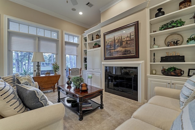 living area featuring built in shelves, light tile patterned floors, visible vents, ornamental molding, and a glass covered fireplace