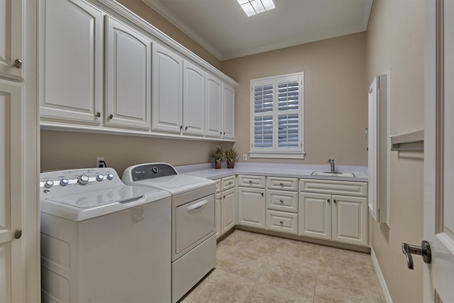 washroom featuring crown molding, washing machine and dryer, light tile patterned floors, cabinet space, and a sink