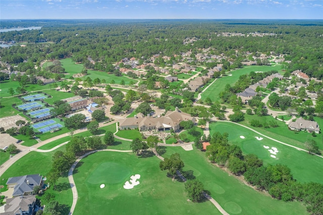 birds eye view of property featuring golf course view, a view of trees, and a residential view