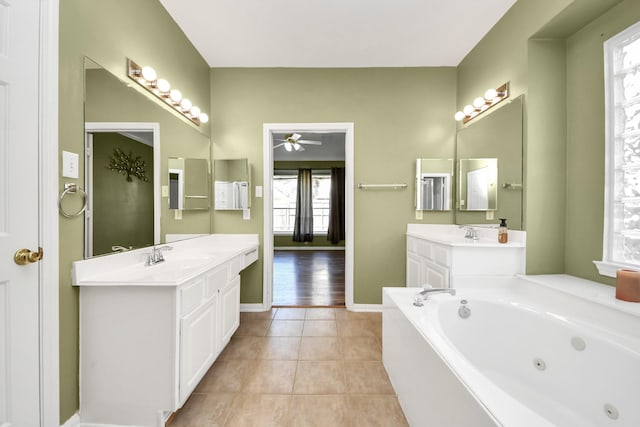 full bathroom featuring tile patterned floors, a jetted tub, baseboards, ceiling fan, and vanity