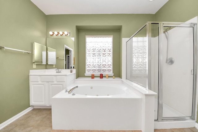 bathroom with tile patterned floors, a tub with jets, a shower stall, and vanity