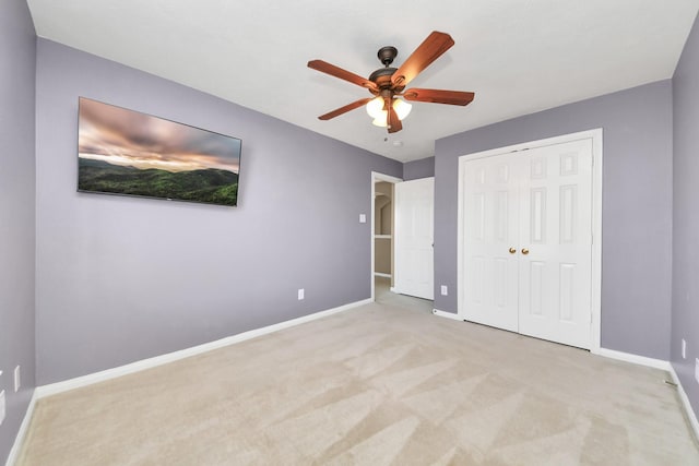 unfurnished bedroom with a ceiling fan, carpet, baseboards, and a closet