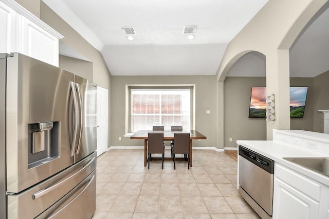 kitchen featuring visible vents, appliances with stainless steel finishes, white cabinets, light countertops, and lofted ceiling