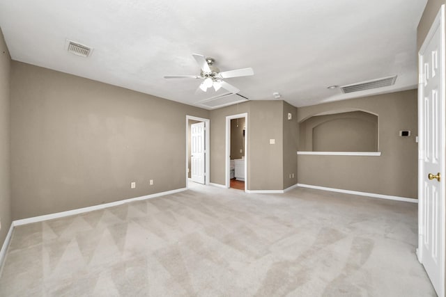 carpeted empty room with visible vents, attic access, and baseboards