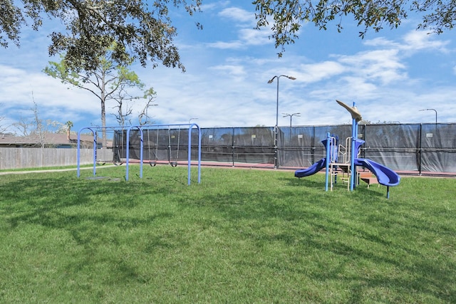 communal playground with a yard and fence