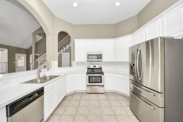 kitchen featuring a sink, appliances with stainless steel finishes, light tile patterned floors, and light countertops